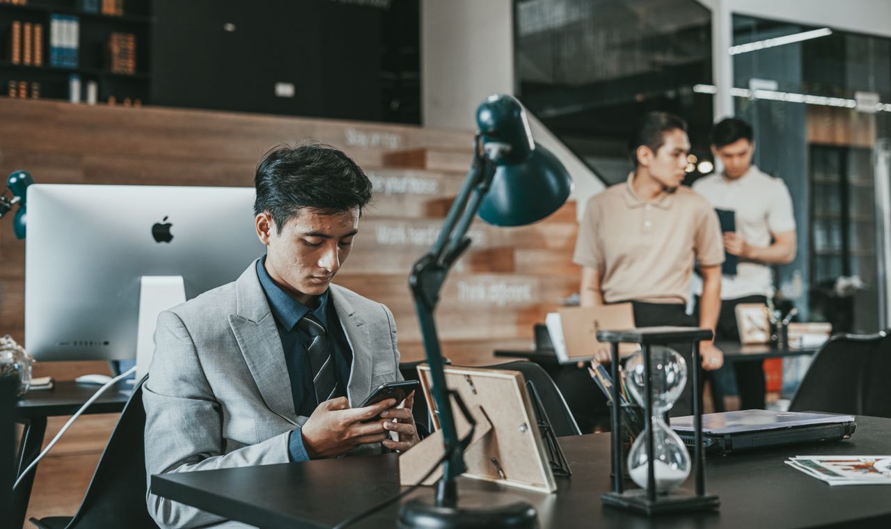 Services Business professionals in suits working at office desks, showcasing modern corporate environment.